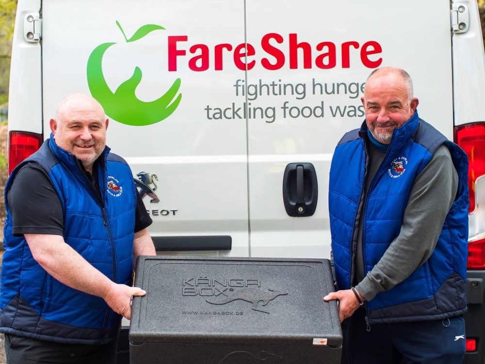 FareShare volunteers with a box of food