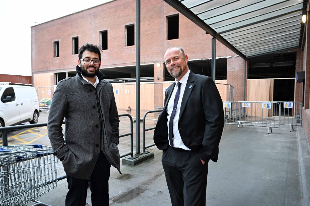 Two people stood in a building that is to be redeveloped