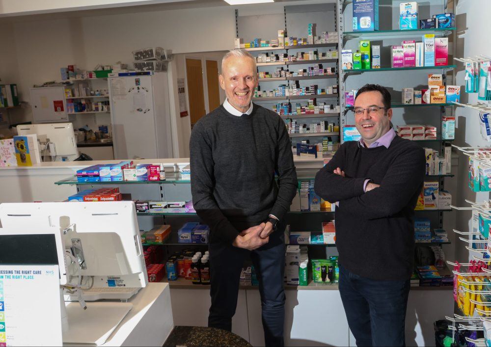 two men standing in Lomond Pharmacy