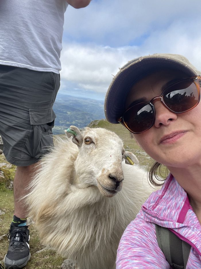 woman posing with a sheep