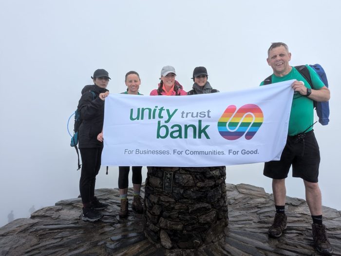 Unity Trust Bank banner at the top of a Welsh mountain